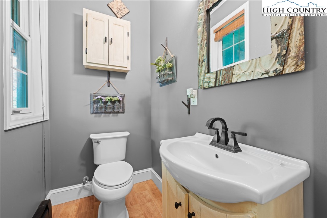 126 Moore Mountain Road Vilas, NC 28692 - Photo 14 of 43 a bathroom with a toilet sink and mirror