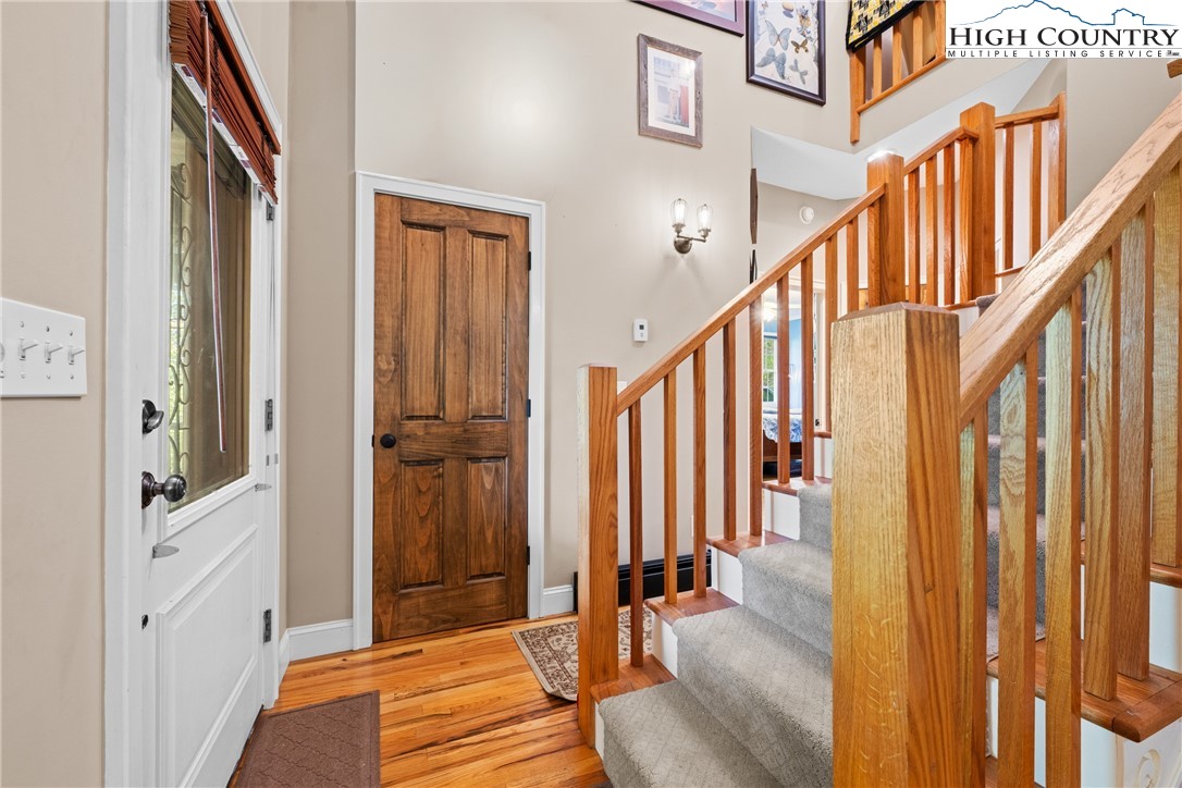 126 Moore Mountain Road Vilas, NC 28692 - Photo 15 of 43 a view of a hallway with wooden floor and staircase