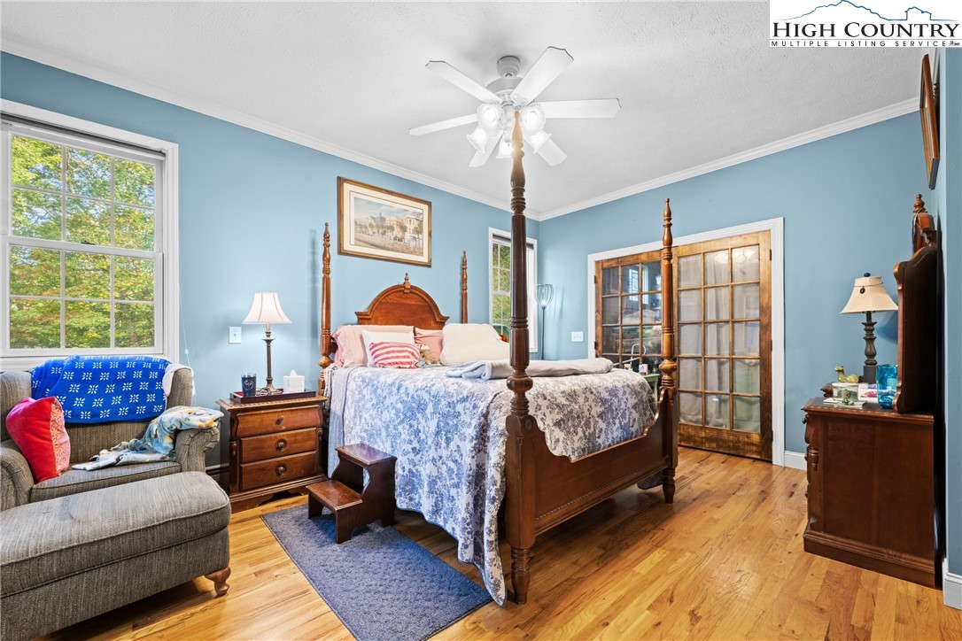 126 Moore Mountain Road Vilas, NC 28692 - Photo 16 of 43 a bedroom with a bed and wooden floor