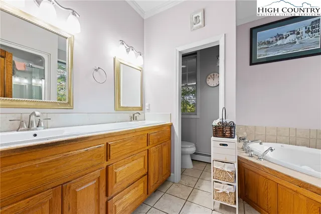 a bathroom with a tub sink and mirror