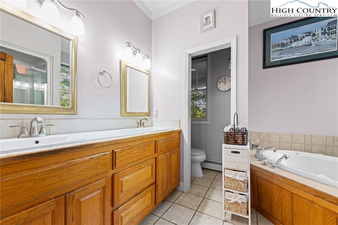 126 Moore Mountain Road Vilas, NC 28692 - Photo 18 of 43 a bathroom with a tub sink and mirror