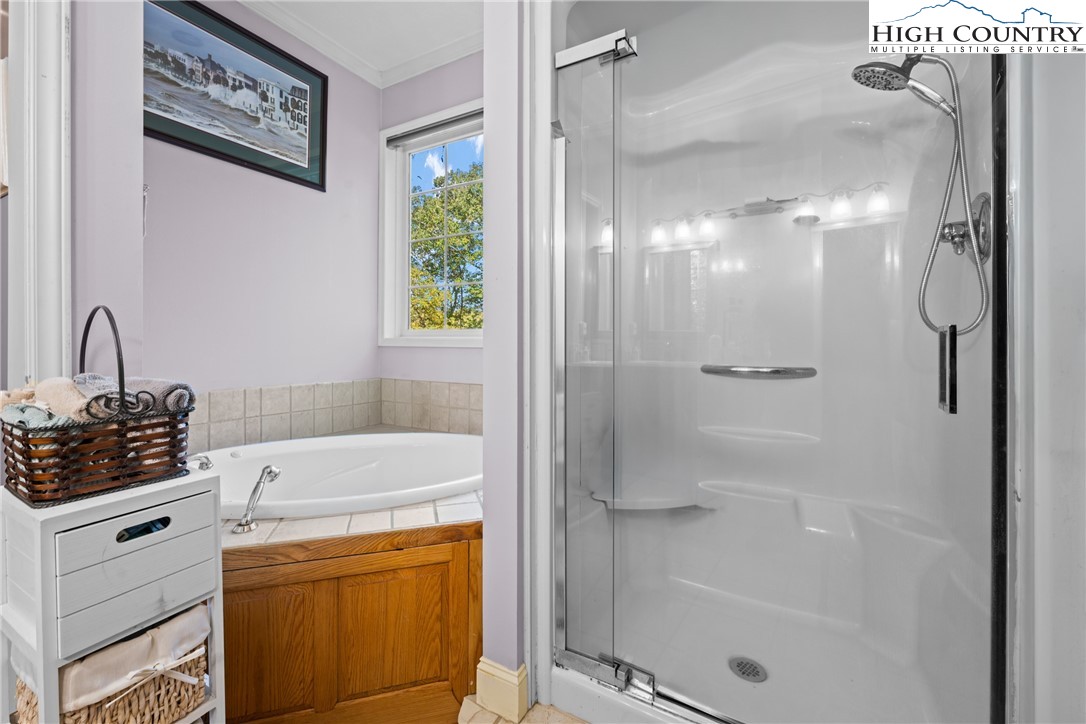126 Moore Mountain Road Vilas, NC 28692 - Photo 19 of 43 a bathroom with a shower sink and mirror