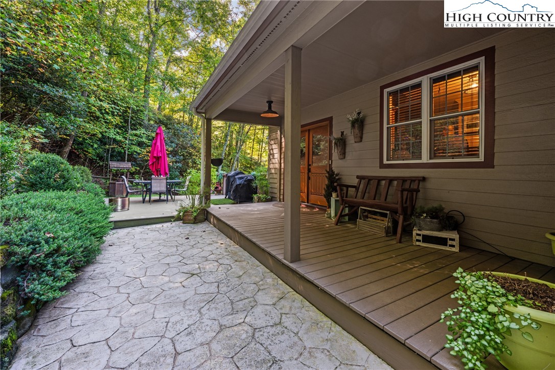 126 Moore Mountain Road Vilas, NC 28692 - Photo 2 of 43 a view of a dinning tables and chairs in patio in front of a house