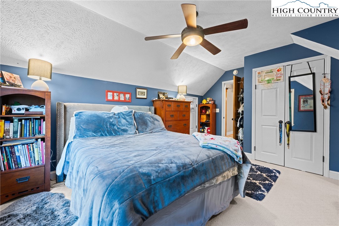 126 Moore Mountain Road Vilas, NC 28692 - Photo 22 of 43 a bedroom with a bed a book shelf and a book shelf