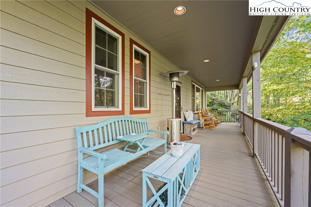 126 Moore Mountain Road Vilas, NC 28692 - Photo 26 of 43 a balcony with wooden floor and furniture
