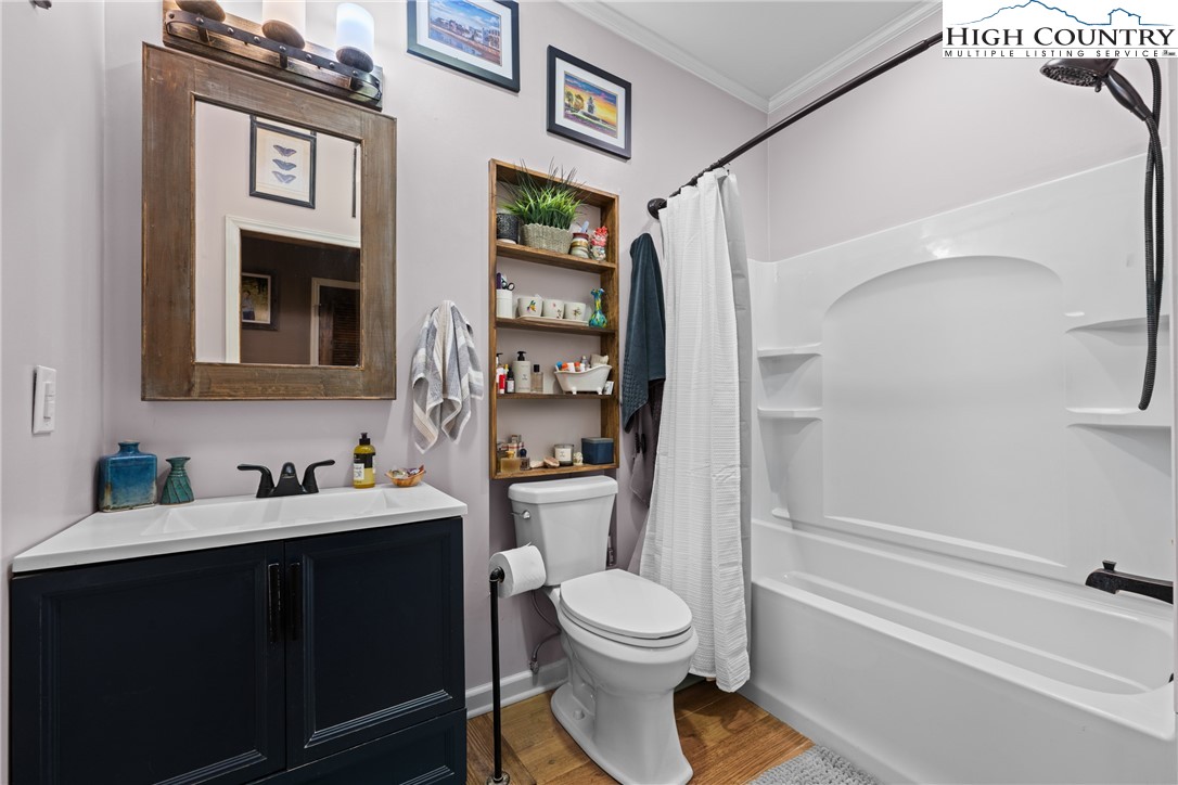 126 Moore Mountain Road Vilas, NC 28692 - Photo 32 of 43 a bathroom with a toilet sink and shower