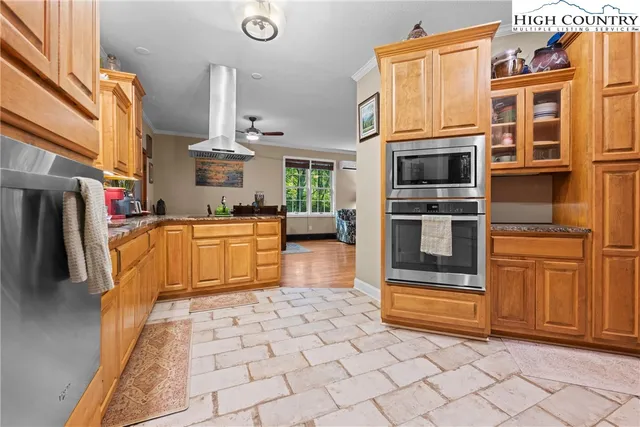 a view of a kitchen with stainless steel appliances and cabinets