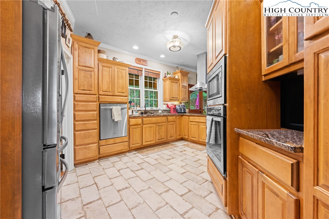 126 Moore Mountain Road Vilas, NC 28692 - Photo 7 of 43 a kitchen with stainless steel appliances granite countertop a refrigerator and a stove