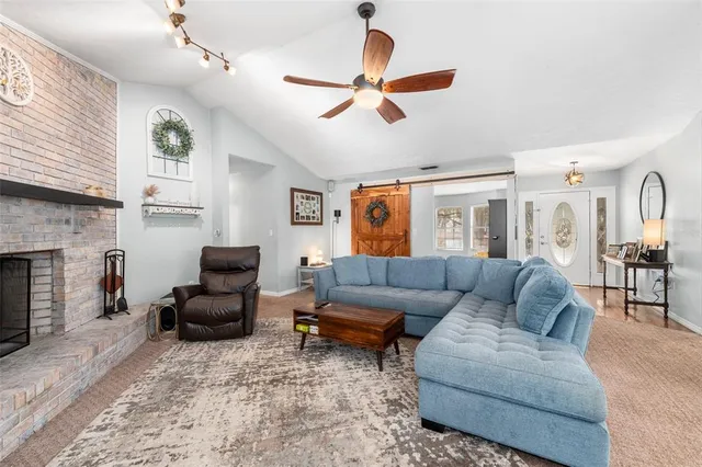 a living room with furniture and a book shelf