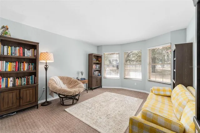 a kitchen with white cabinets appliances and a chandelier
