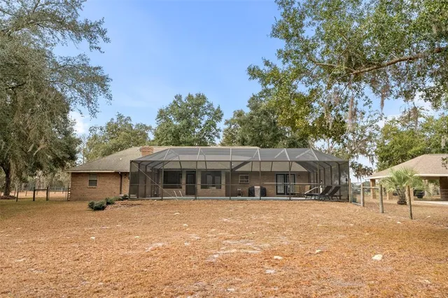 a front view of a house with a yard covered in snow