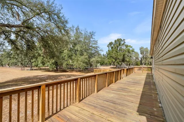 a kitchen with stainless steel appliances a dining table chairs microwave and refrigerator