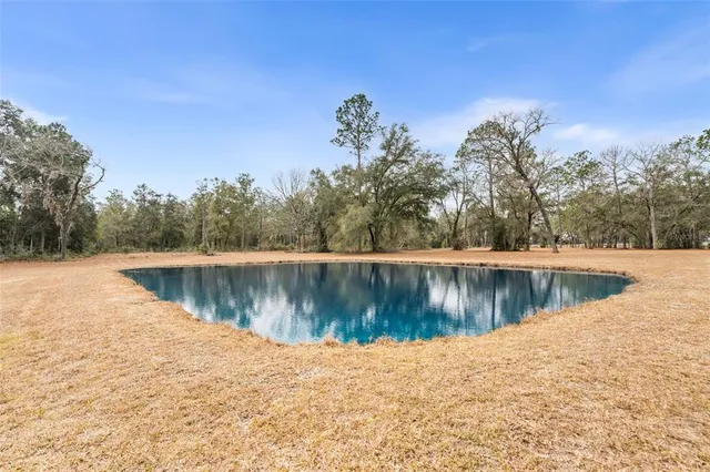 a view of a house with a yard and sitting area