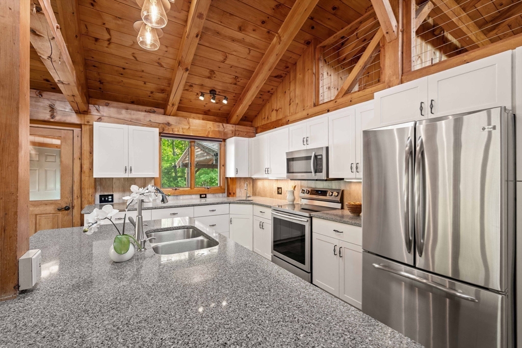 3 Whitman Place Beverly, MA 01915 - Photo 5 of 34 a kitchen with refrigerator and stove