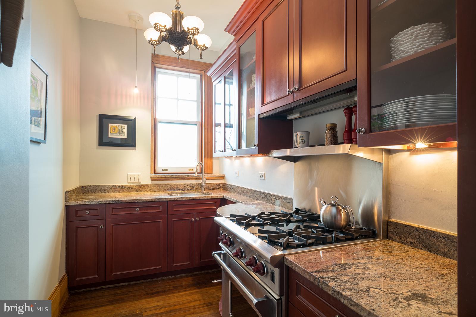 2853 Ontario Road Northwest, Unit 421 Washington, DC 20009 - Photo 16 of 35 a kitchen with a stove and a sink