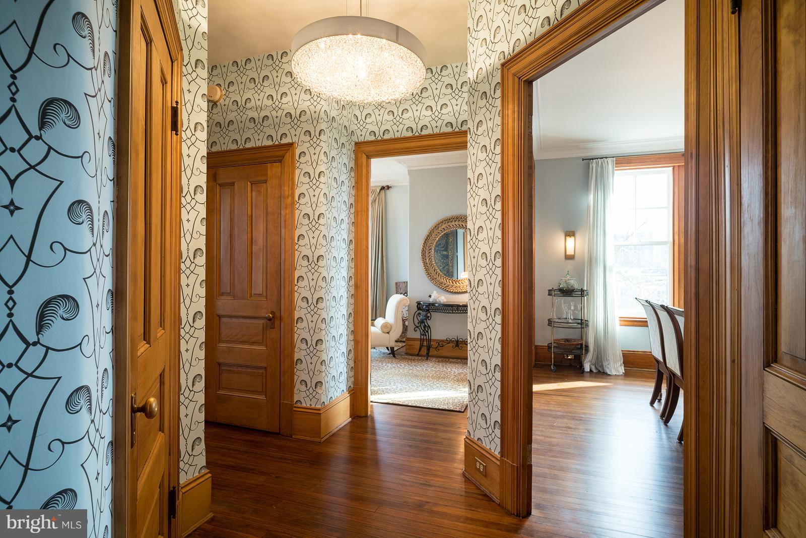 2853 Ontario Road Northwest, Unit 421 Washington, DC 20009 - Photo 3 of 35 a view of a hallway with wooden floor and a livingroom
