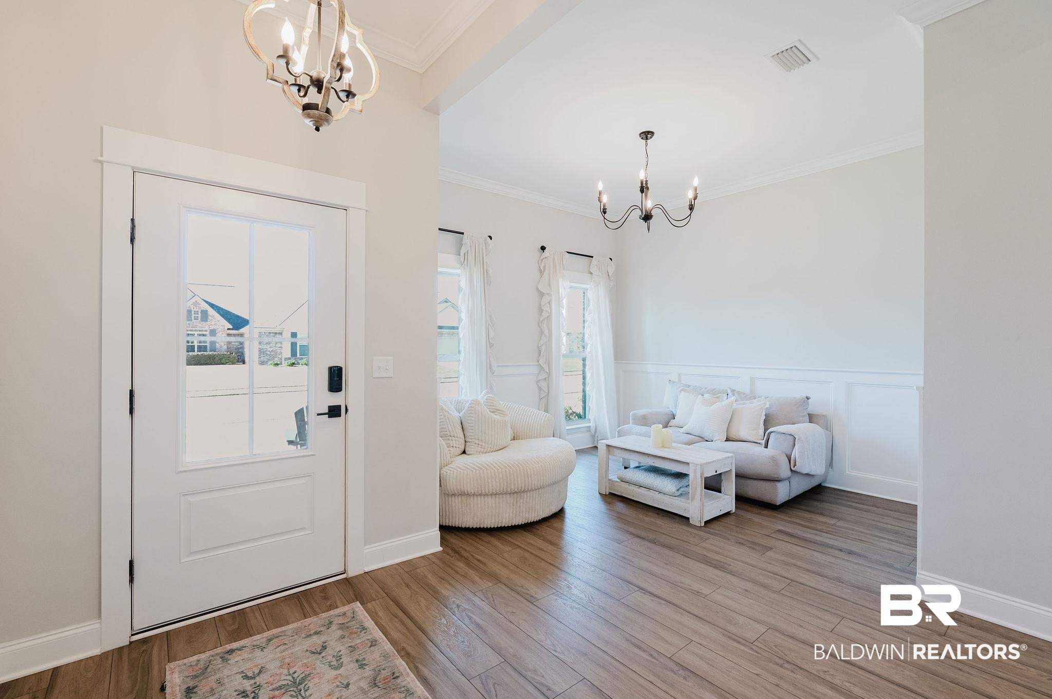 7872 Calverton Street Foley, AL 36535 - Photo 25 of 76 Entryway featuring wood-finish flooring, a glass-paned entry door with a smart lock, and a decorative chandelier