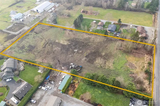 an aerial view of a house with a yard