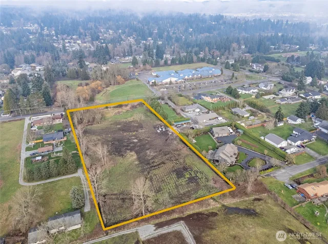 an aerial view of a residential houses with outdoor space