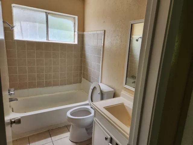 a bathroom with a toilet a sink a bathtub and shower