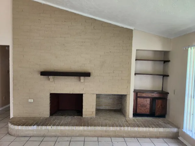 a view of an empty room and fire place