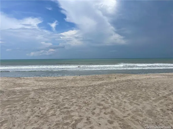 a view of a swimming pool with a table and chairs