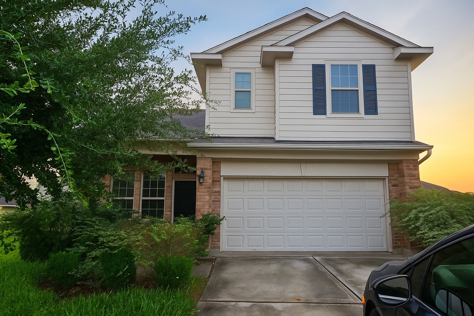 a front view of a house with a yard and garage