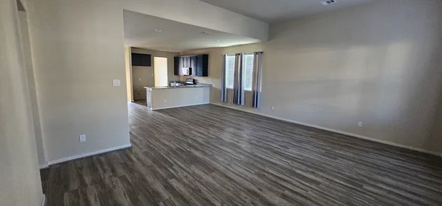 a view of a kitchen from the hallway with a sink