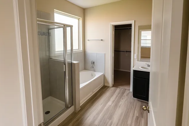 a bathroom with a bathtub and a shower