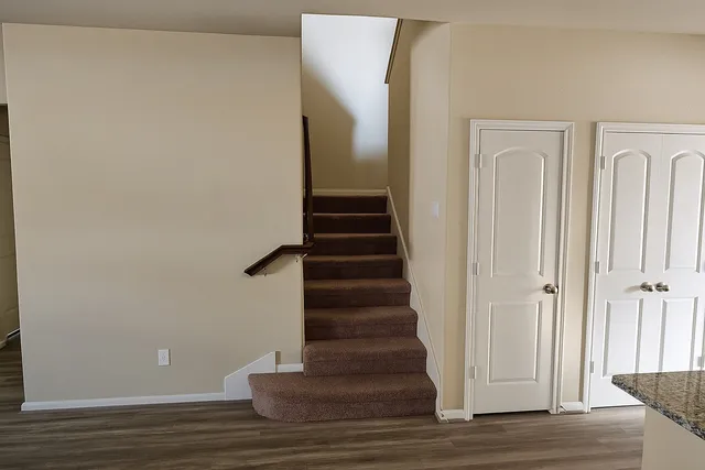 a view of hallway with wooden floor