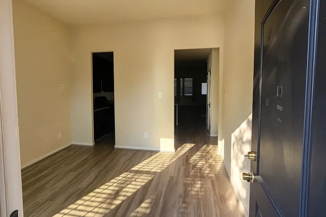 a view of an empty room and a window