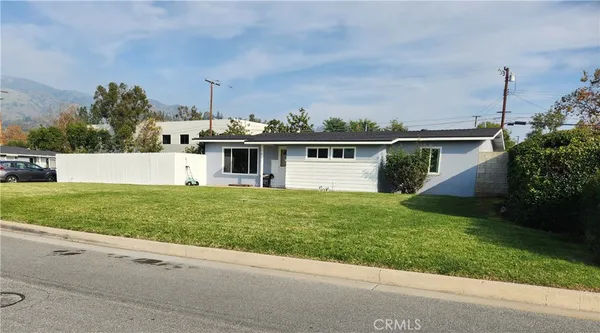 a view of a house with a garden and yard