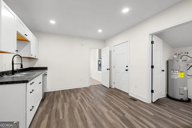 a view of storage and utility room with wooden floor