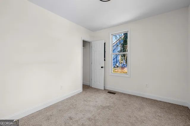 a kitchen with sink a microwave and cabinets