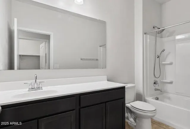 a bathroom with a sink toilet double vanity and shower