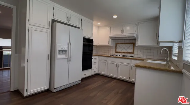 a kitchen with stainless steel appliances a refrigerator stove and sink