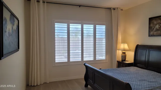 a bedroom with a bed and a window