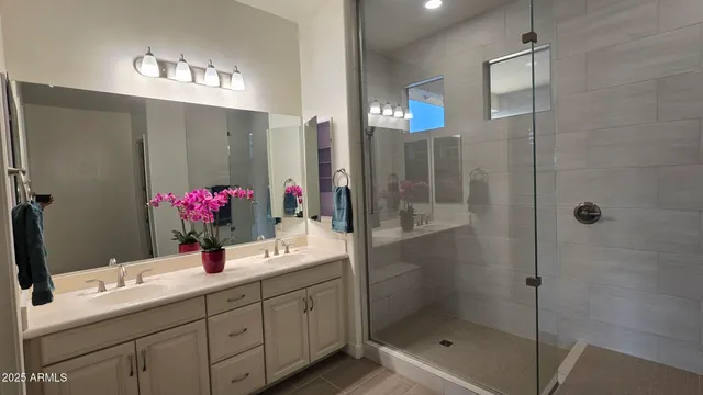 a bathroom with a shower sink and mirror