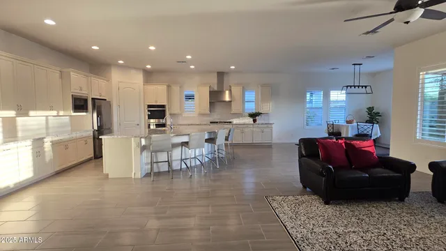 a living room with lots of furniture and kitchen view