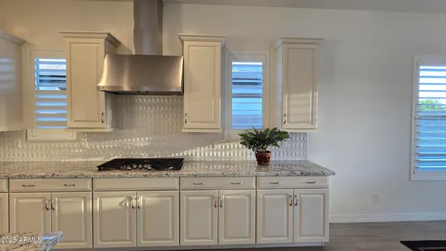a kitchen with stainless steel appliances a sink and cabinets
