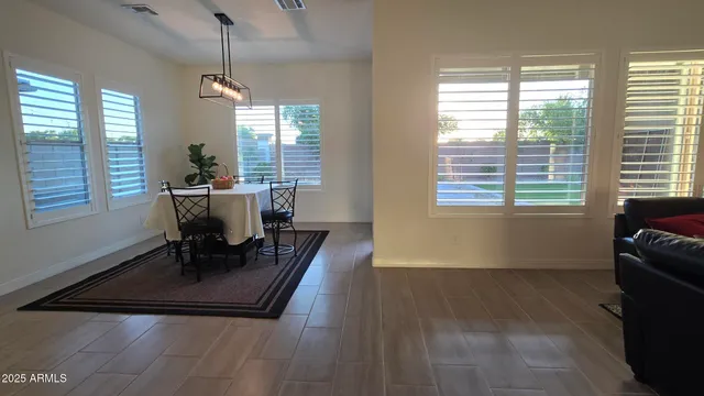 a view of a dining room with furniture window and outside view