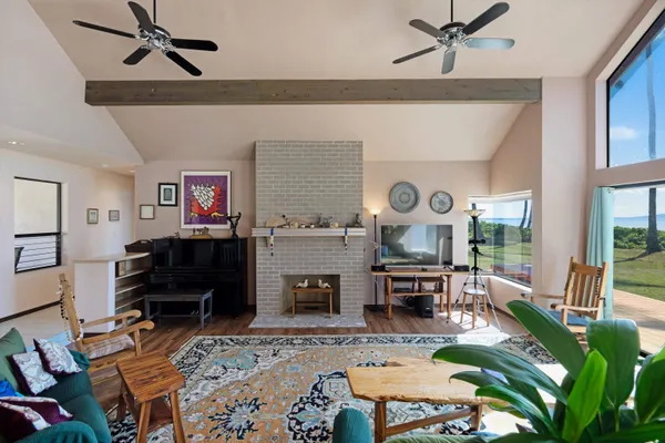 a kitchen with stainless steel appliances granite countertop a dining table chairs and refrigerator