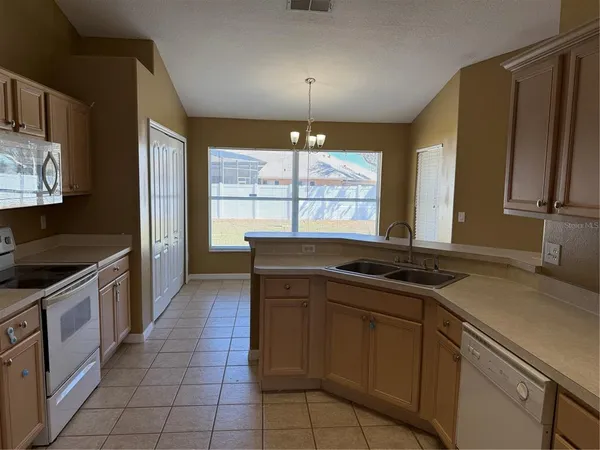a kitchen with a sink stove and cabinets