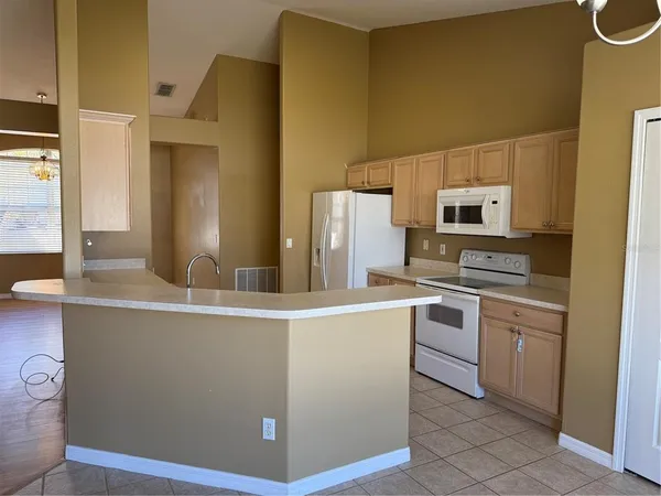 a kitchen with a sink appliances and cabinets