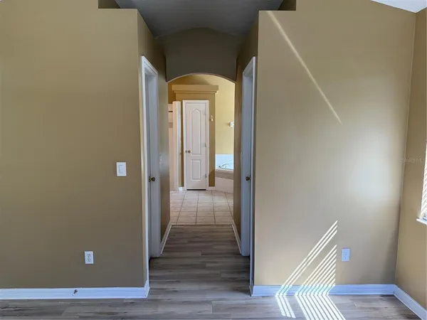 a view of a hallway with wooden floor