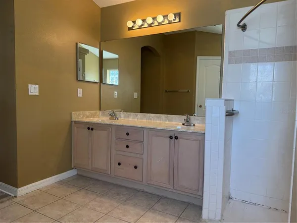 a bathroom with a double vanity sink and mirror