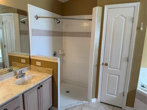 a bathroom with a granite countertop shower sink and vanity