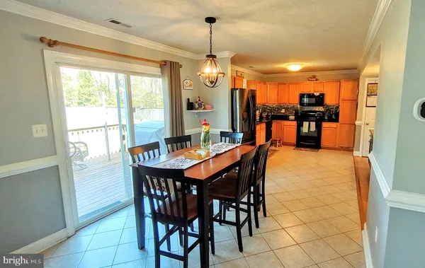 a living room with furniture and a dining table