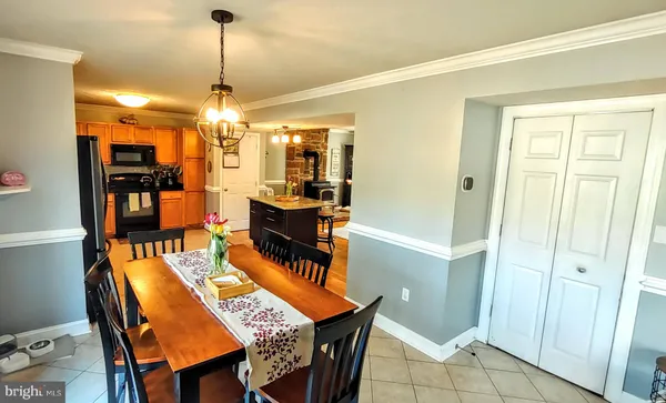 a view of a livingroom with furniture a fireplace a chandelier and wooden floor