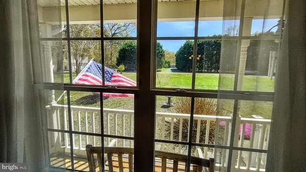 a view of a bedroom with a bed and wooden floor
